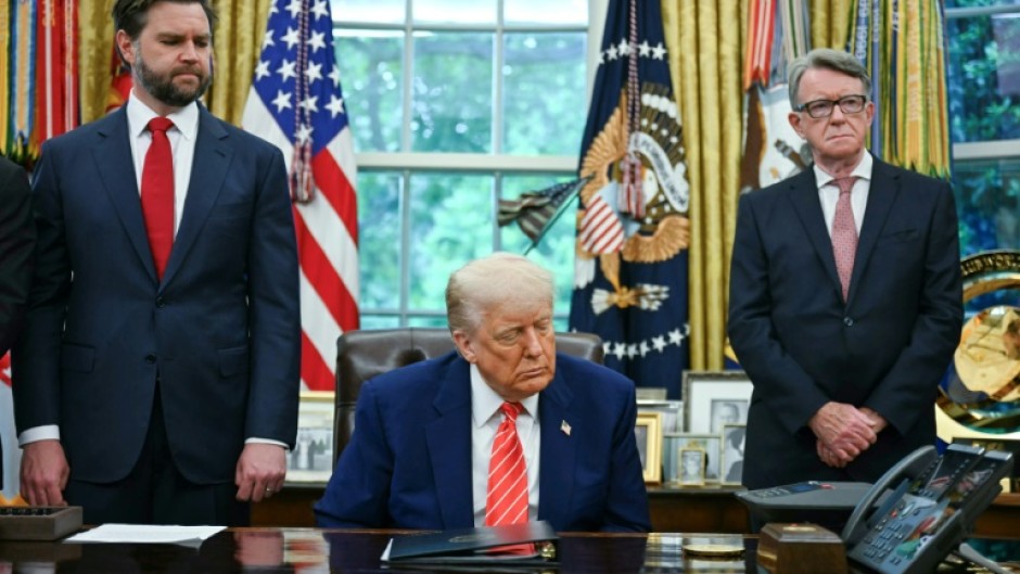 US President Donald Trump makes a trade announcement as US Vice President JD Vance (L), and British ambassador to the United States Peter Mandelson (R), look on in the Oval Office of the White House in Washington, DC, on May 8, 2025. US President Donald Trump on announced a "full and comprehensive" trade agreement with Britain, which would be the first such deal since he launched his global tariffs blitz.