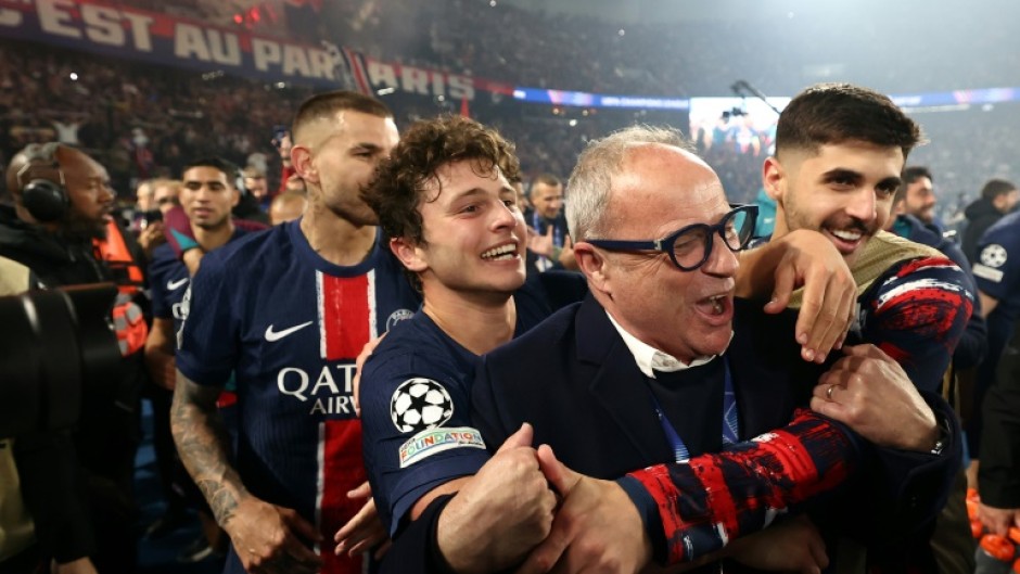PSG players, including Joao Neves (C), and sporting director Luis Campos celebrate at the Parc des Princes after reaching the Champions League final