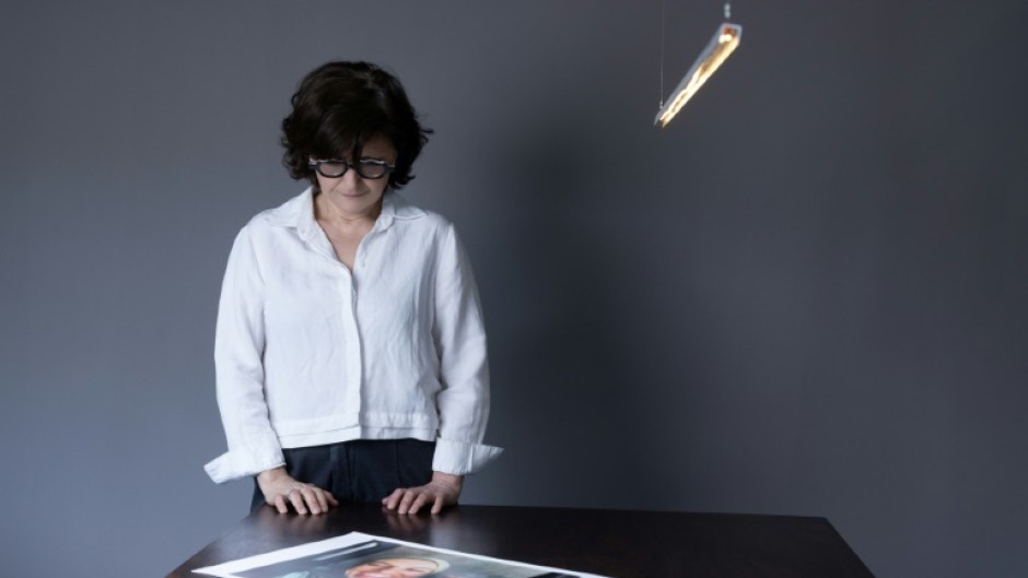Iranian filmmaker and activist Sepideh Farsi looks at a portrait of the Palestinian photographer Fatima Hassouna, who was killed in the bombing of her house in the Gaza Strip
