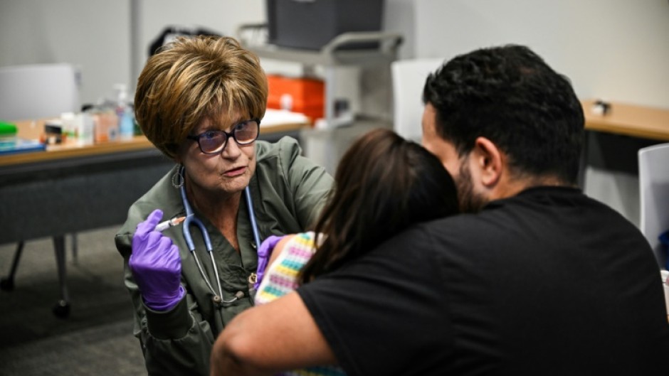 Administering the measles vaccine to a child at a health center in Lubbock, Texas