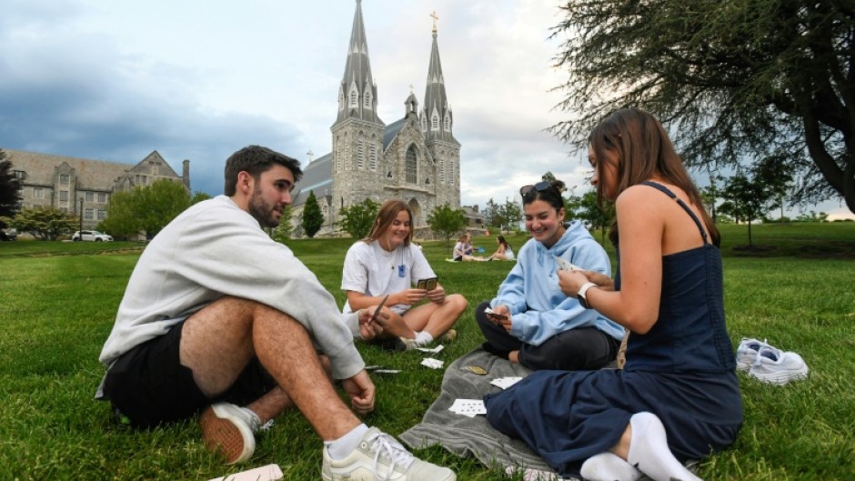 Students play cards outside of St. Thomas of Villanova Church at the campus of Villanova University in Villanova, Pennsylvania, where Pope Leo XIV studied and graduated in 1977