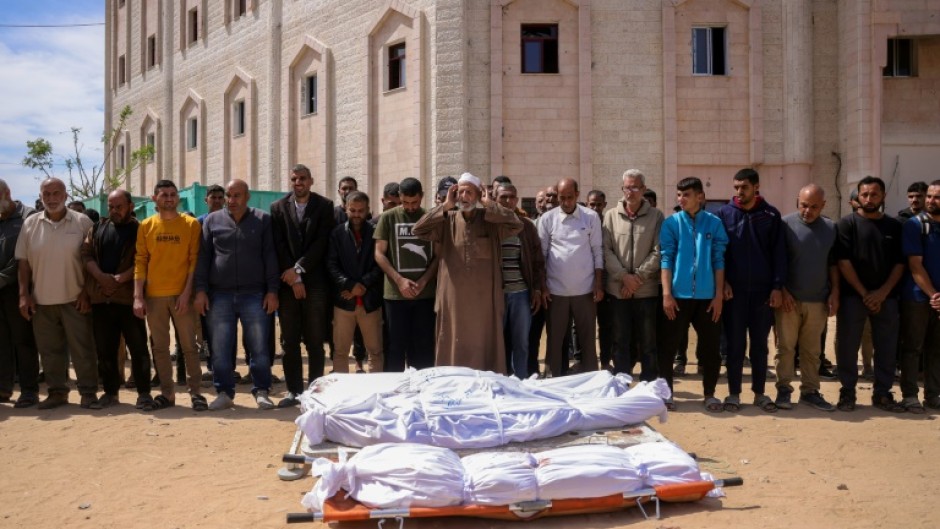 Mourners pray for the dead after Israeli strikes in Gaza
