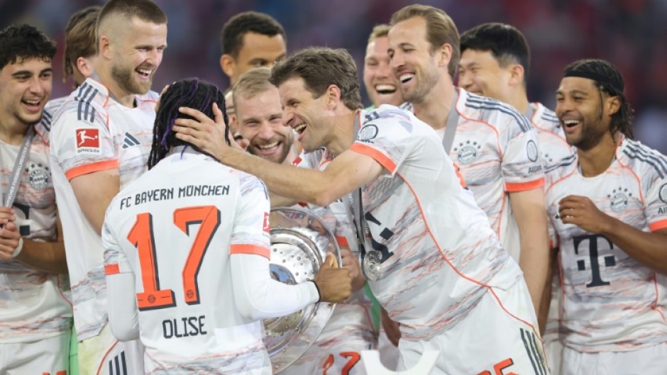 Bayern Munich's players congratulate Michael Olise after winning the league title.