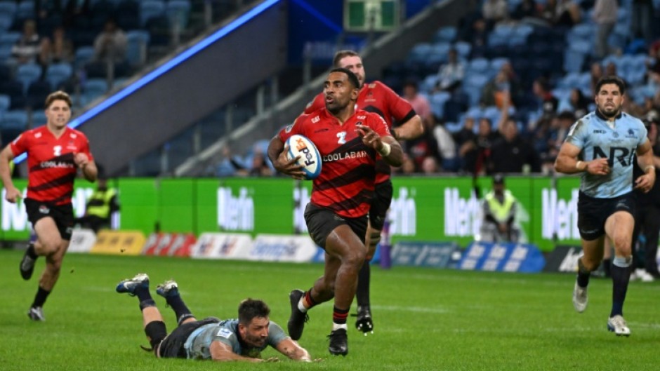 Canterbury Crusaders' Sevu Reece (C) runs the ball for a try during a Super Rugby match against the New South Wales' Waratahs in Sydney on May 16, 2025