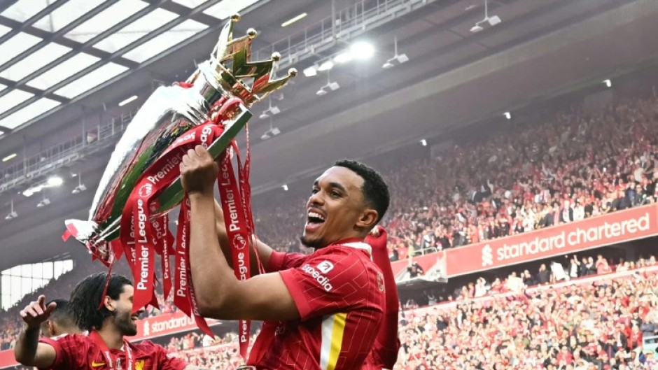 Liverpool's Trent Alexander-Arnold celebrates with the Premier League trophy