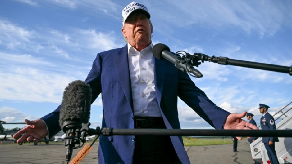 US President Donald Trump speaks to journalists before boarding Air Force One from Morristown Municipal Airport in Morristown, New Jersey