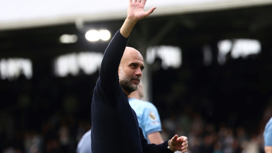 Manchester City manager Pep Guardiola waves to the crowd after his side's 2-0 win away to Fulham in their final game of the Premier League season
