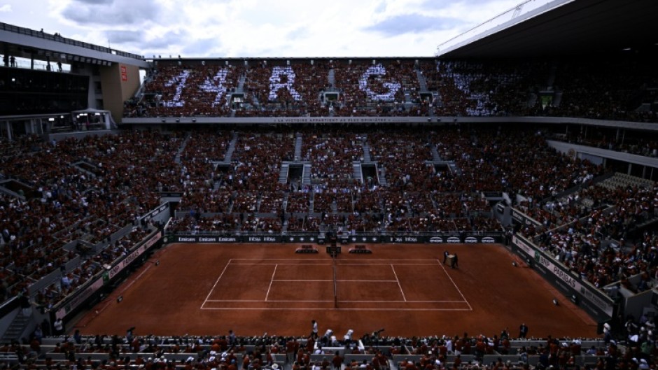 Organisers handed out free T-shirts to fans for Rafael Nadal's ceremony at Roland Garros