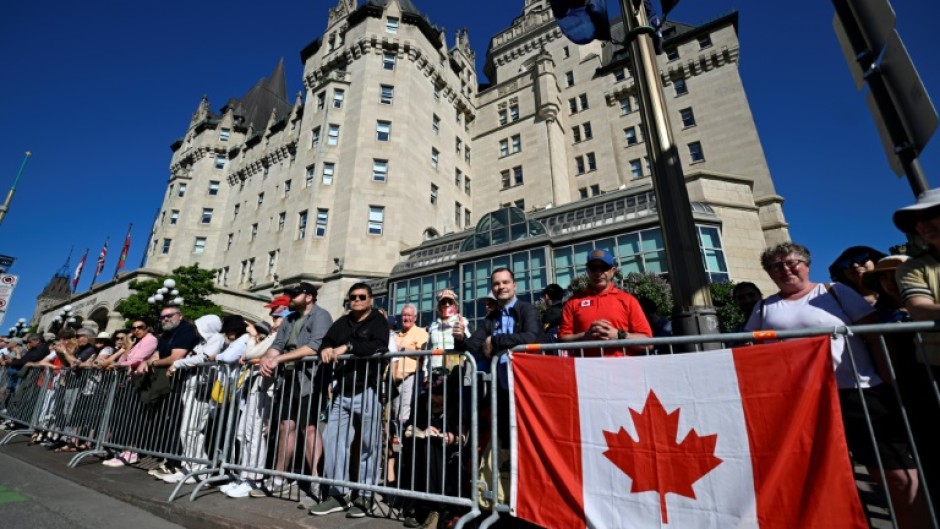 Thousands gathered along a parade route early Tuesday morning for a chance to see their monarch