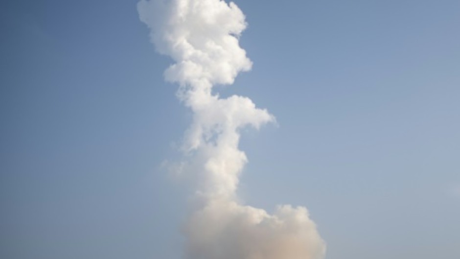 A plume of exhaust from the rocket boosters is left behind after the SpaceX Starship rocket launched from Starbase, Texas, as seen from South Padre Island on May 27, 2025