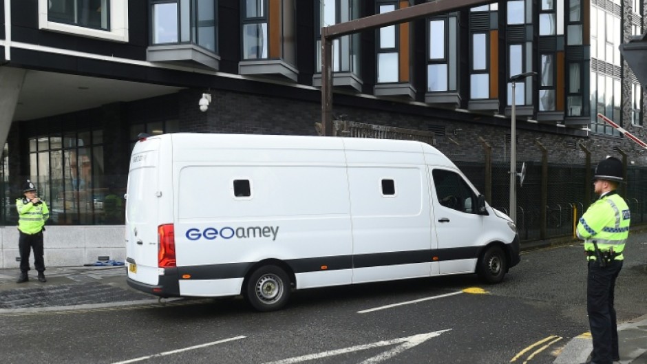 A prison van passes police officers outside Liverpool Magistrates' Court as a 53-year-old former Marine was due to appear for the first time facing seven charges of driving into crowds of football fans
