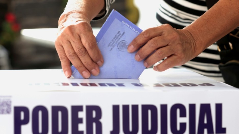 A woman casts her vote during elections making Mexico the world's only country to choose judges and magistrates at all levels through a popular vote