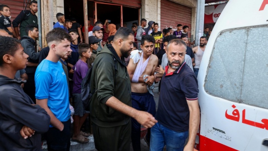 Palestinian rescuers arrive in an ambulance to evacuate injured people after an Israeli drone reportedly opened fire on civilian gatherings near an aid distribution point not far from the so-called Netzarim checkpoint