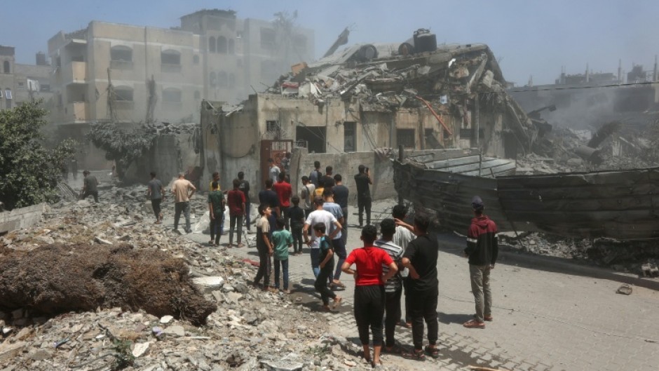 Palestinians inspect the rubble following Israeli strikes on a family home in Al-Tuffah neighbourhood in Gaza City