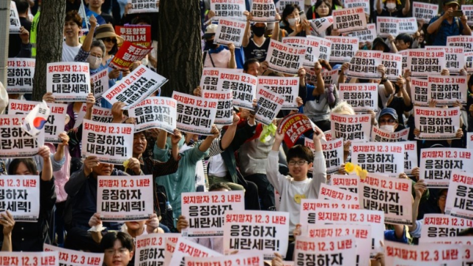 People hold placards that read 'Let's not forget the December 3 insurrection' during a campaign rally ahead of South Korea's June 3 poll