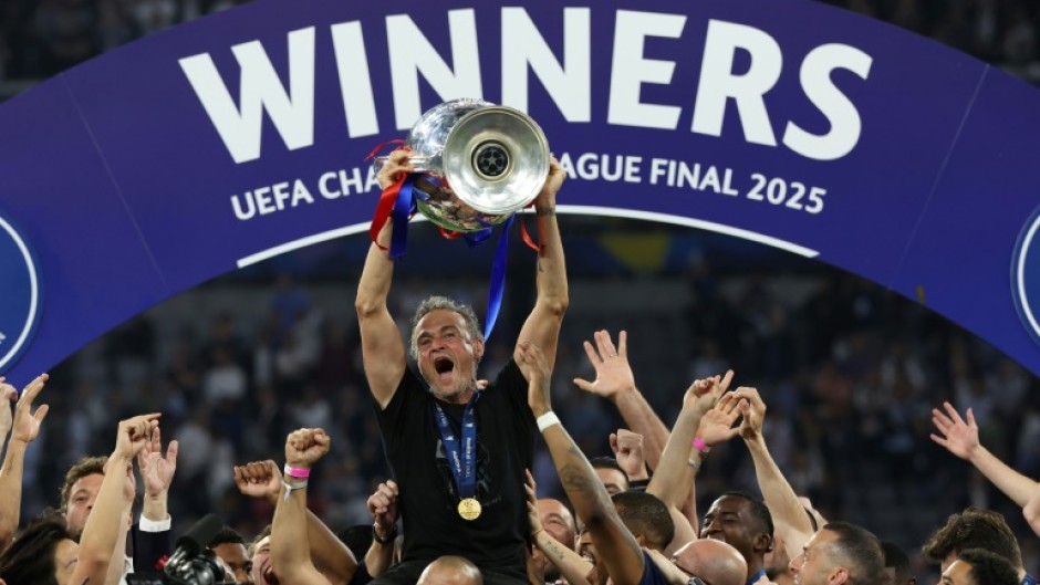 Paris Saint-Germain coach Luis Enrique lifts the Champions League trophy after his side outclassed Inter Milan in the final