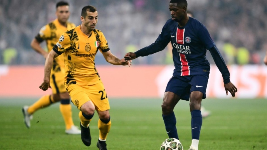 Ousmane Dembele screening the ball from Inter Milan's Henrikh Mkhitaryan