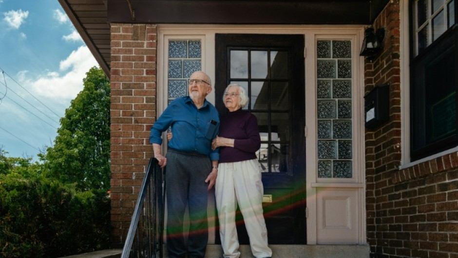 Veteran activists Joyce and Joseph Ellwanger stand on the steps of their home in Milwaukee, Wisconsin