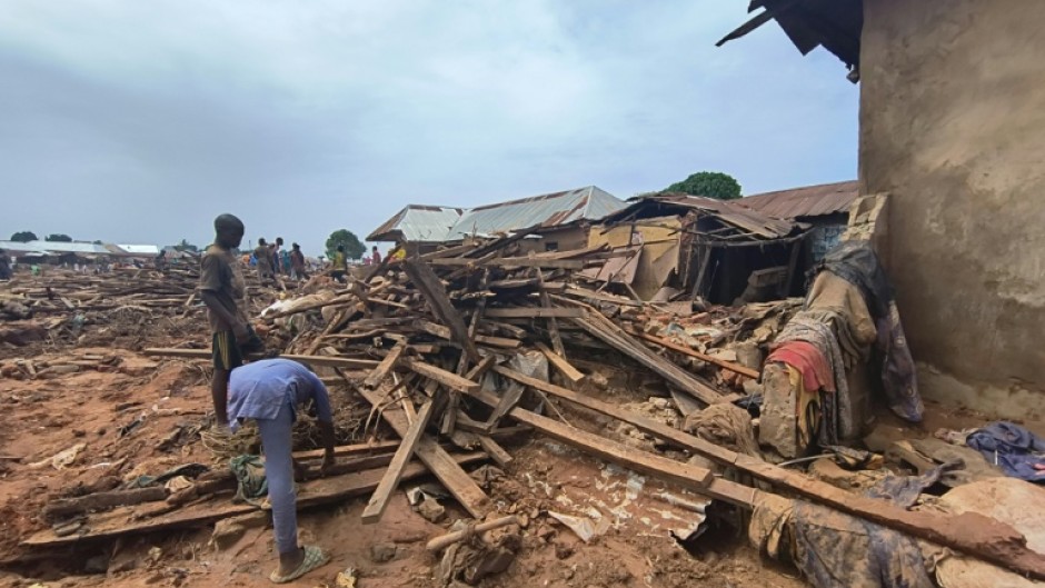 People picked through debris from damaged buildings in Mokwa