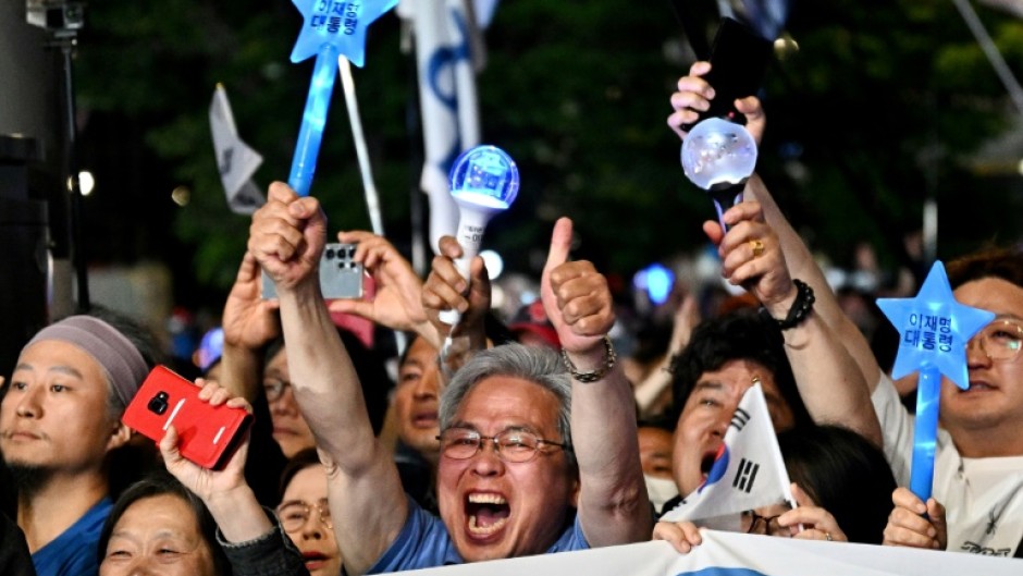 Lee supporters celebrate after exit polls show him on track to win South Korea's presidential election by a wide margin