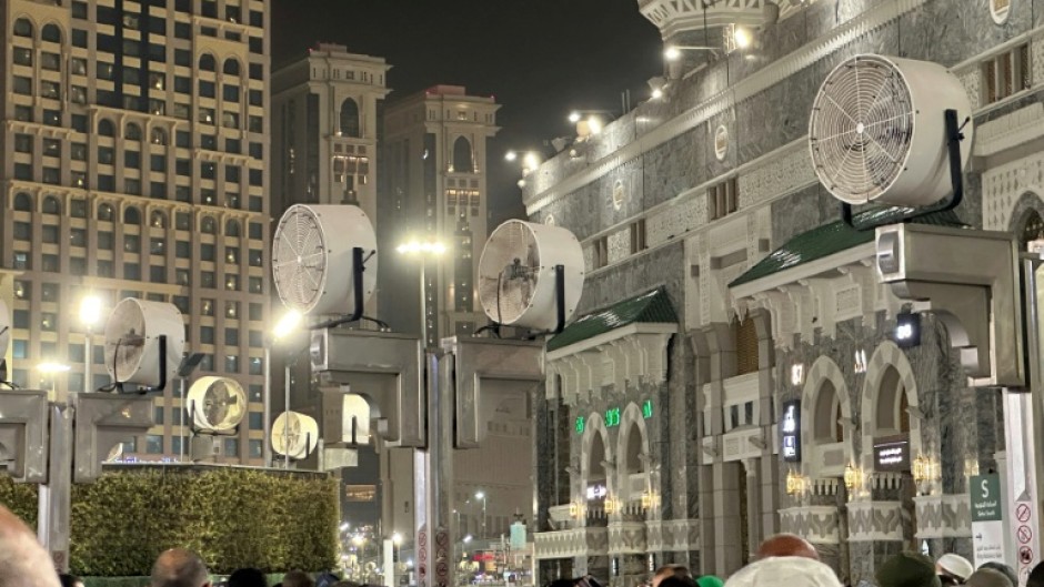 Big fans blow air as Muslim worshippers gather at the Grand Mosque in Mecca