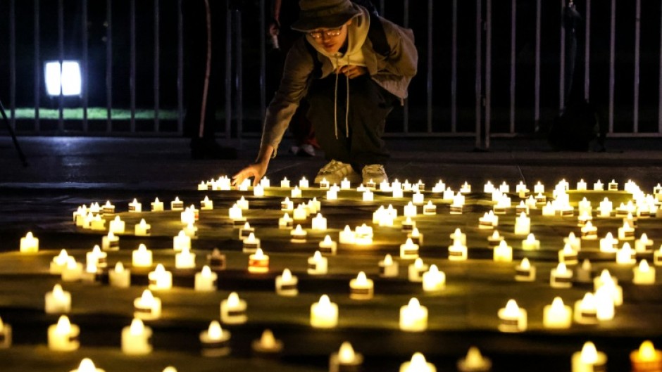 A mourner places a candle at Taipei's Liberty Square to mark the 36th anniversary of China's Tiananmen Square crackdown in 1989