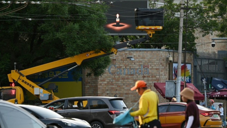 In Beijing, a cherry picker blocked a screen at the Canadian embassy showing an image of a candle, the symbol commonly used to pay tribute to Tiananmen victims