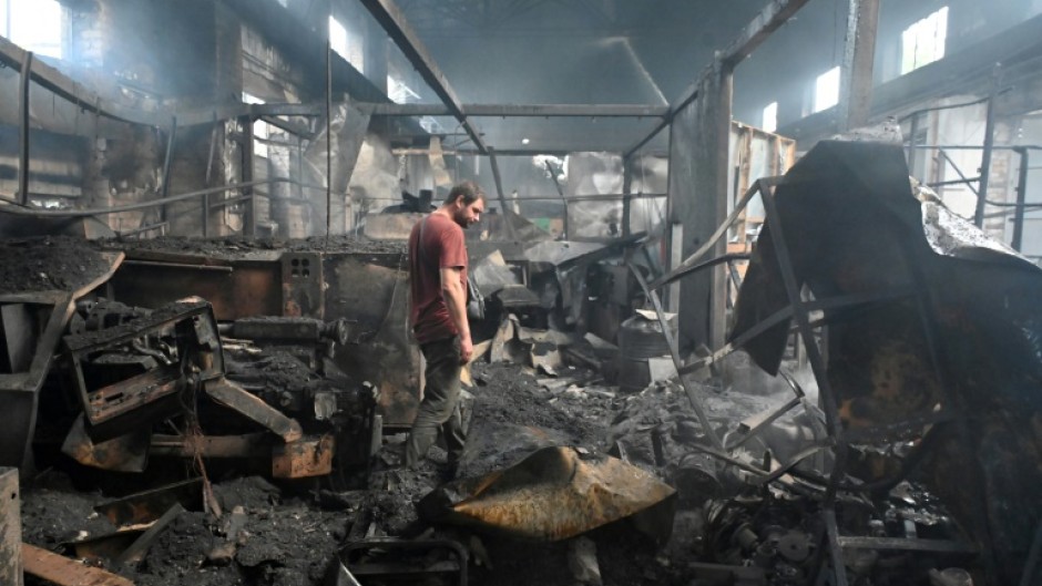 A man stands in a damaged building following an air attack in Kharkiv, Ukraine's second-largest city