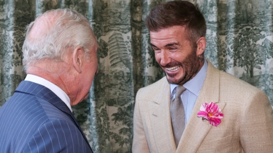 Britain's King Charles III speaks with former England captain David Beckham at the Chelsea Flower Show in London in May 2025