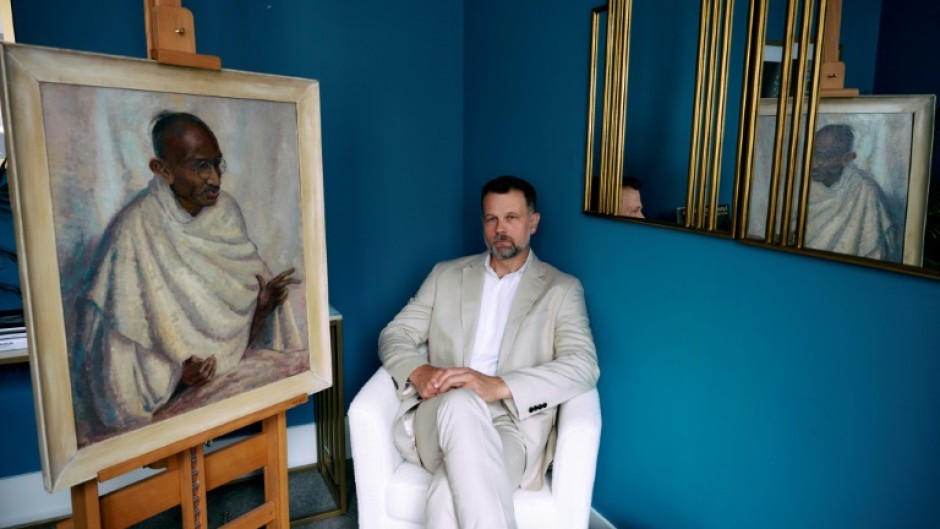 Caspar Leighton with a portrait by his great-aunt of Indian independence leader Mahatma Gandhi