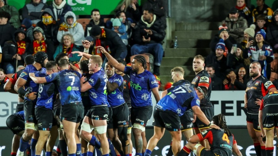 Auckland Blues players celebrate after beating the Waikato Chiefs