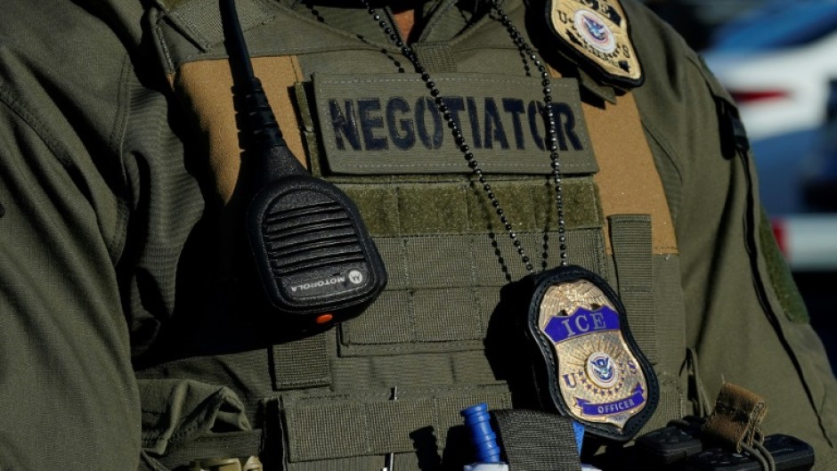 This file photo shows an Immigration and Customs Enforcement (ICE) agent standing near a newly converted immigrant detention centre in New Jersey in May