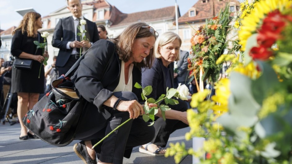 Mourners cried, hugged and left flowers, candles and letters to the victims in Graz