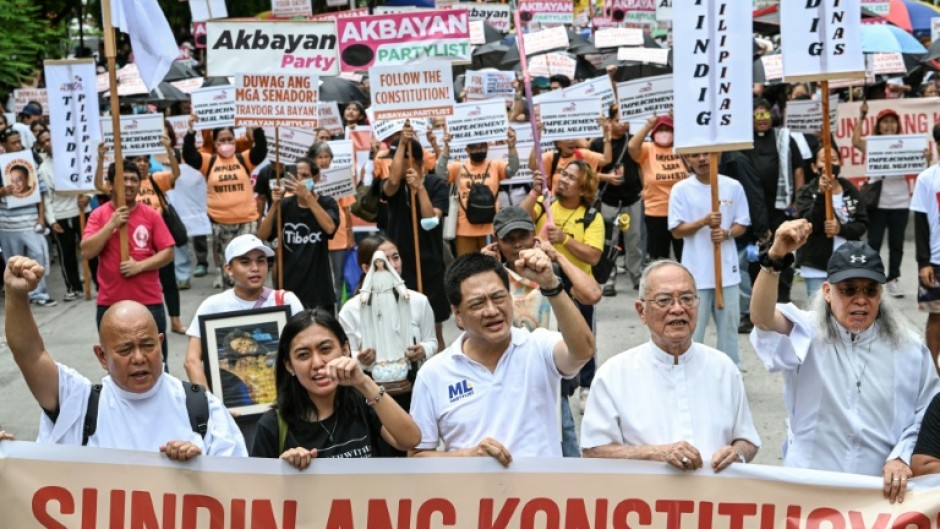 People protest following the Senate's decision on the impeachment trial of Philippine Vice President Sara Duterte