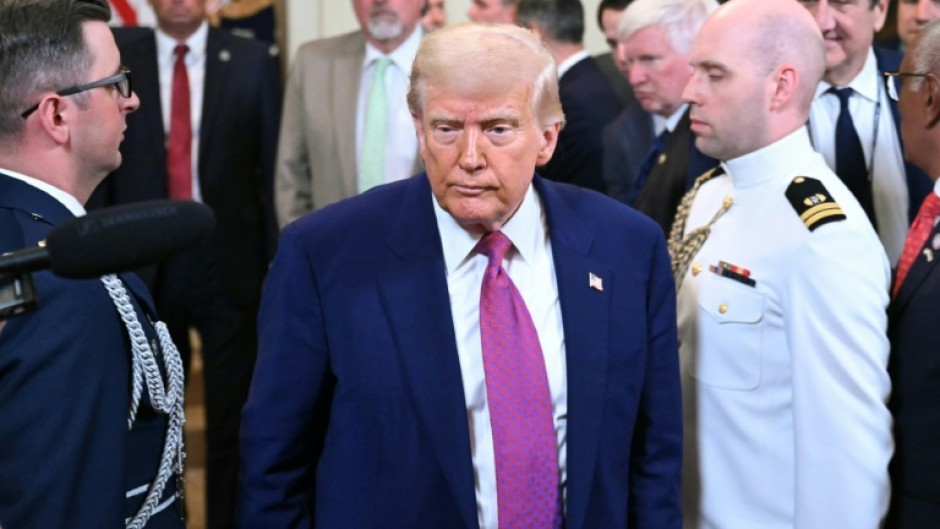 US President Donald Trump departs after signing a bill in the East Room of the White House