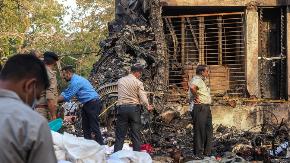 Rescuer workers and investigators comb through the crash site