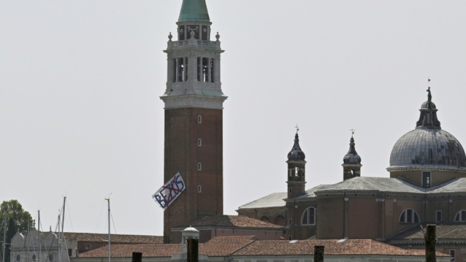 Some residents hung a huge banner with an X over Jeff Bezos's name on a belltower overlooking the Venice lagoon