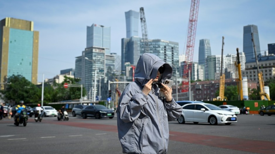 Beijing officials encouraged people to limit outdoor activity and drink fluids to avoid heastroke