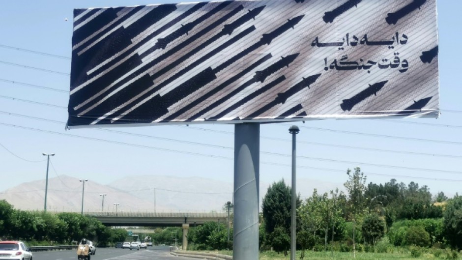 Commuters drive past an anti-Israel billboard in Tehran