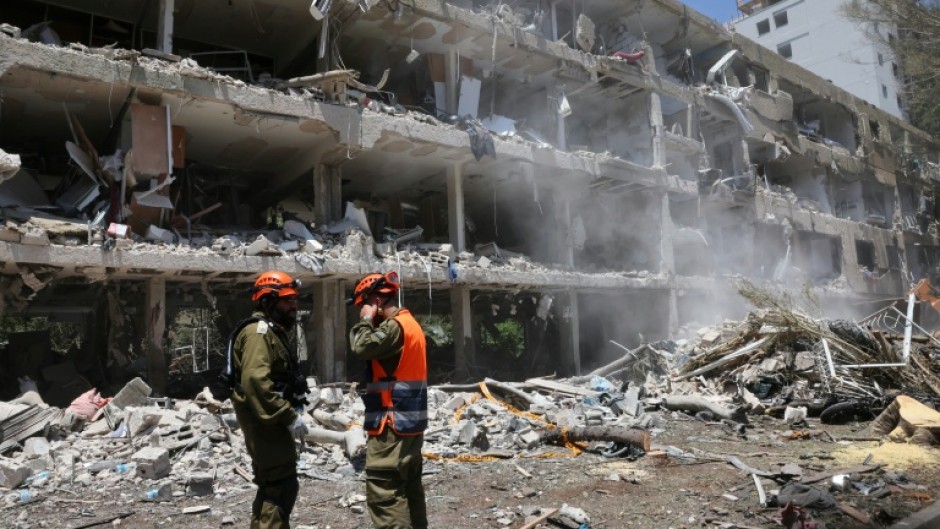 Israeli forces at the site of an Iranian missile strike in Tel Aviv