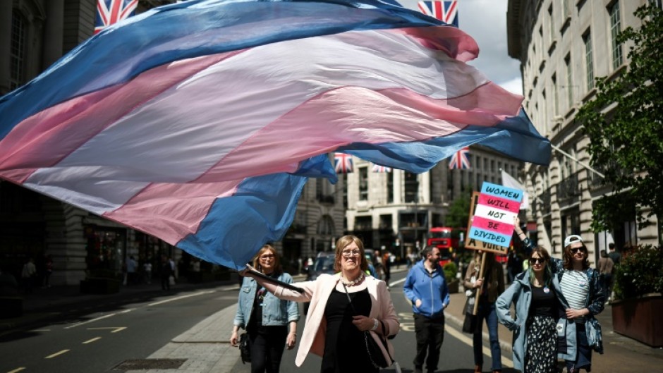 A protester with a transgender pride flag during a march in London in May 2025