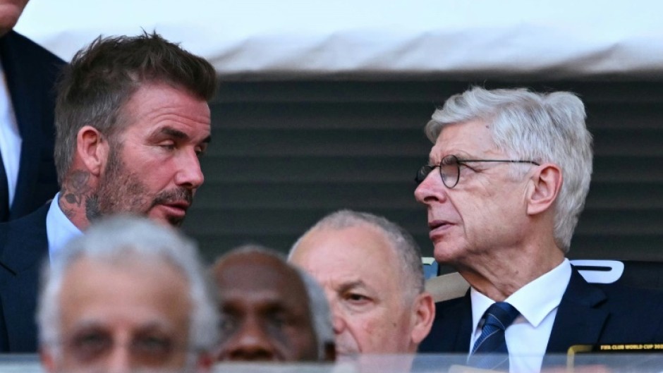 FIFA's Arsene Wenger talks with David Beckham during the Club World Cup's opening match between Egypt's Al Ahly and Inter Miami at the Hard Rock stadium