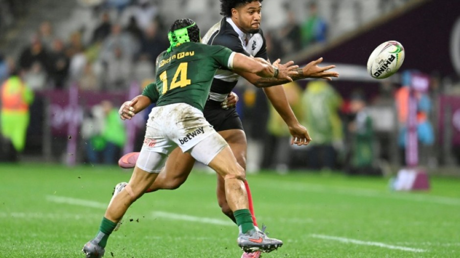 South Africa winger Cheslin Kolbe (L) tackles Barbarians centre Leicester Fainga'anuku at Cape Town Stadium
