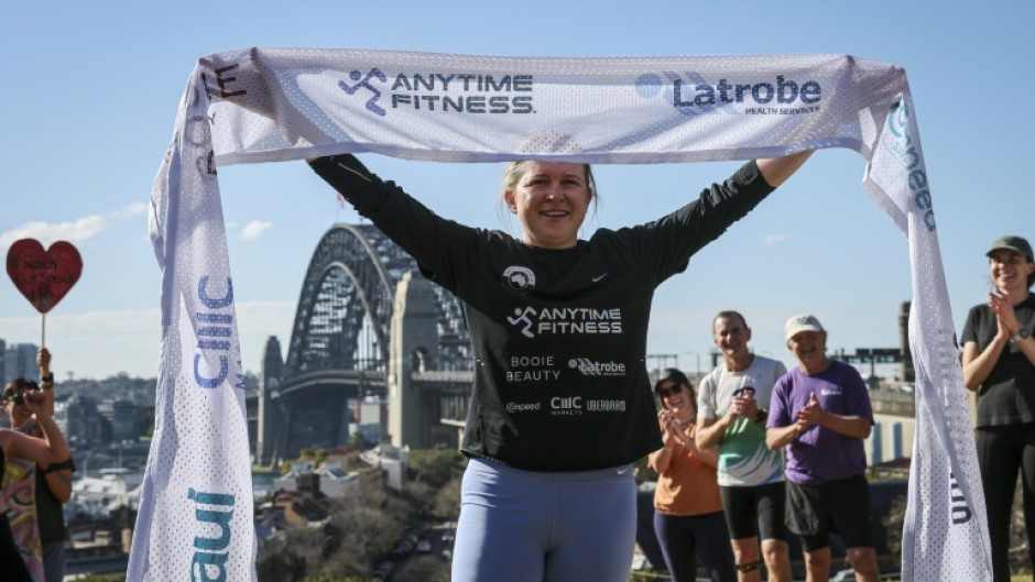 Ultra long-distance runner Fran Hurndall completed a 3,800-kilometre (2,360-mile) charity run across Australia in Sydney, claiming the fastest time on record for a woman