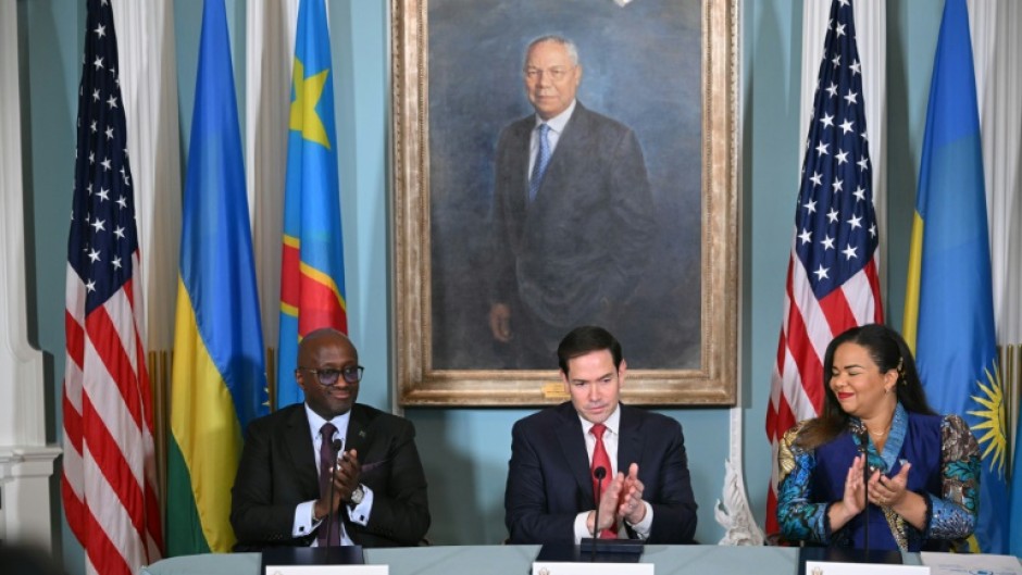 US Secretary of State Marco Rubio, Democratic Republic of the Congo Foreign Minister Therese Kayikwamba Wagner and Rwandan Foreign Minister Olivier Nduhungirehe applaud after signing a peace agreement in Washington