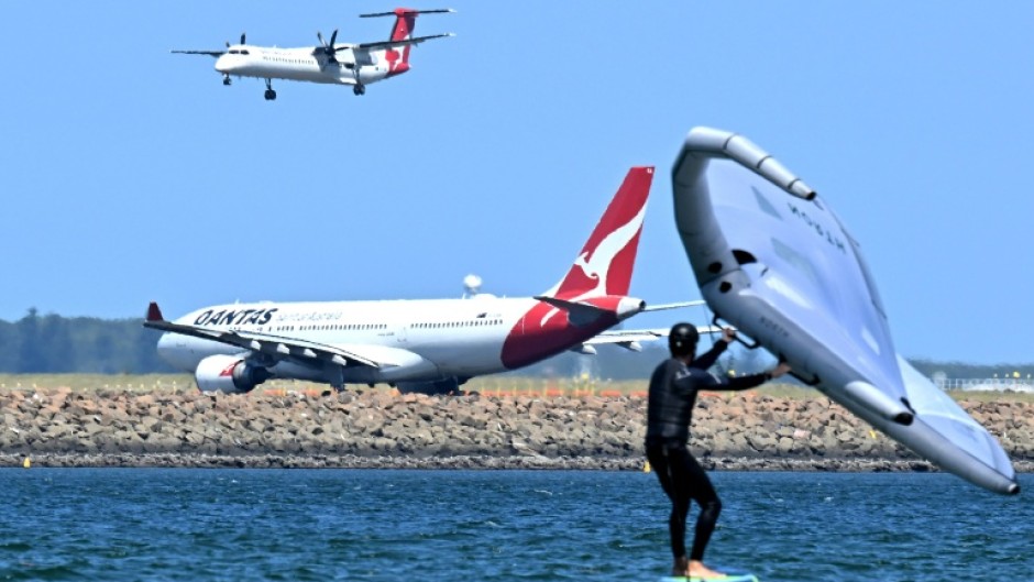 A Qantas plane waits to take off at Sydney International Airport