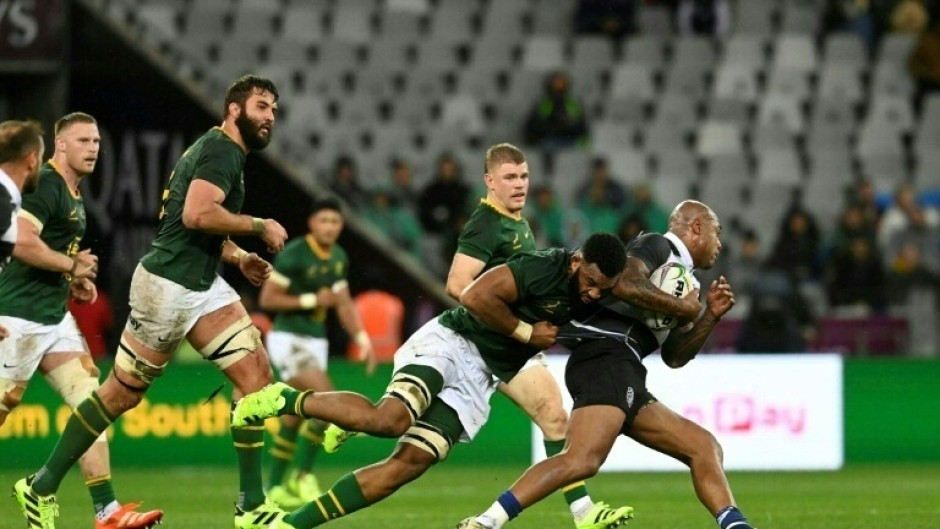 South Africa's Vincent Tshituka (L) tackles New Zealand's Jacob Ratumaitavuki-Kneepkens during the international rugby union match against the Barbarians in Cape Town