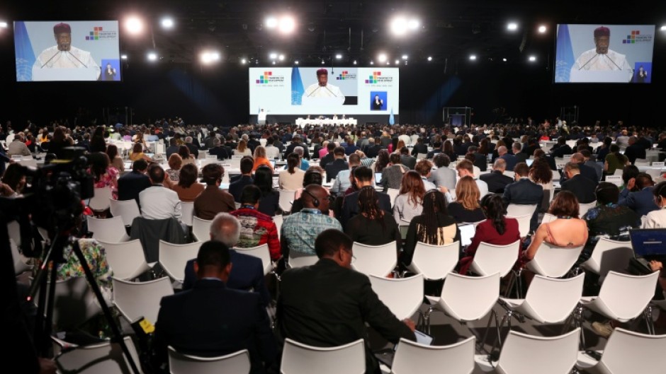 Delegates attend a plenary meeting at the UN 4th International Conference on Financing and Development in Seville on Monday