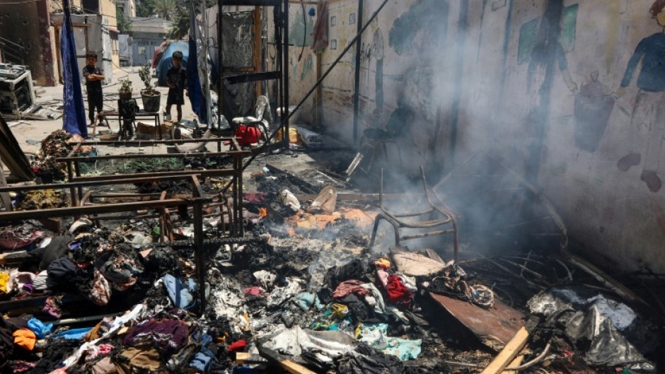 Piles of debris smouldered in the Gaza City school compound hit on Thursday