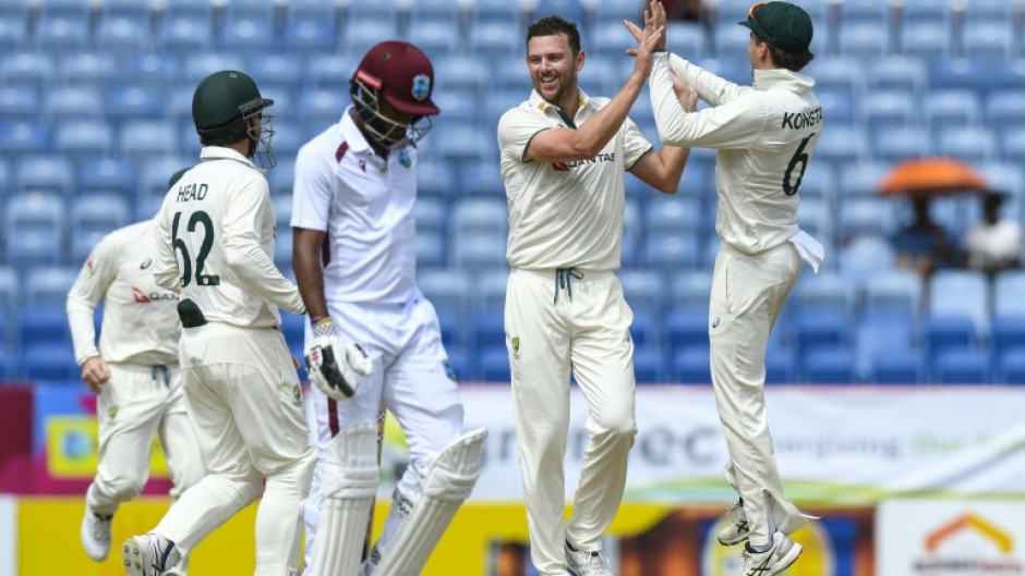 Josh Hazlewood (2R) celebrates removing West Indies opener Kraigg Brathwaite for a duck